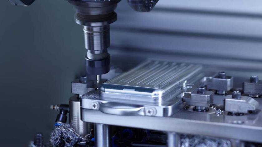 Technician operating machinery in a plastic molding manufacturing plant